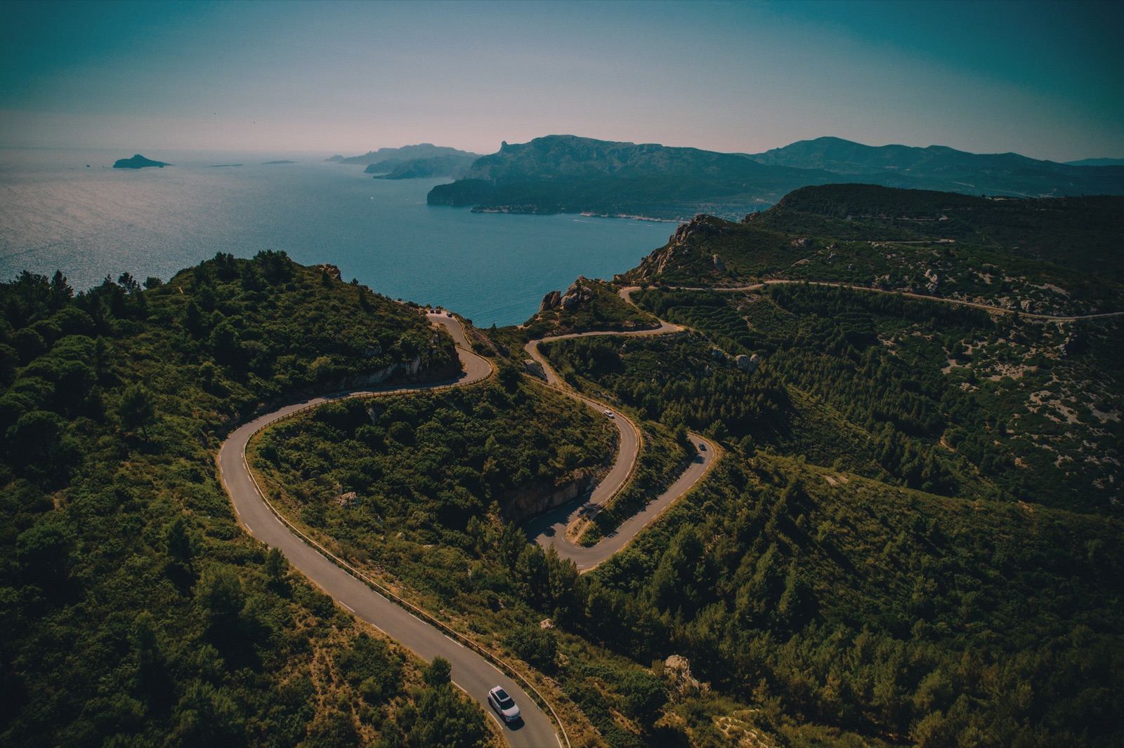 Switchback road winding toward the sea