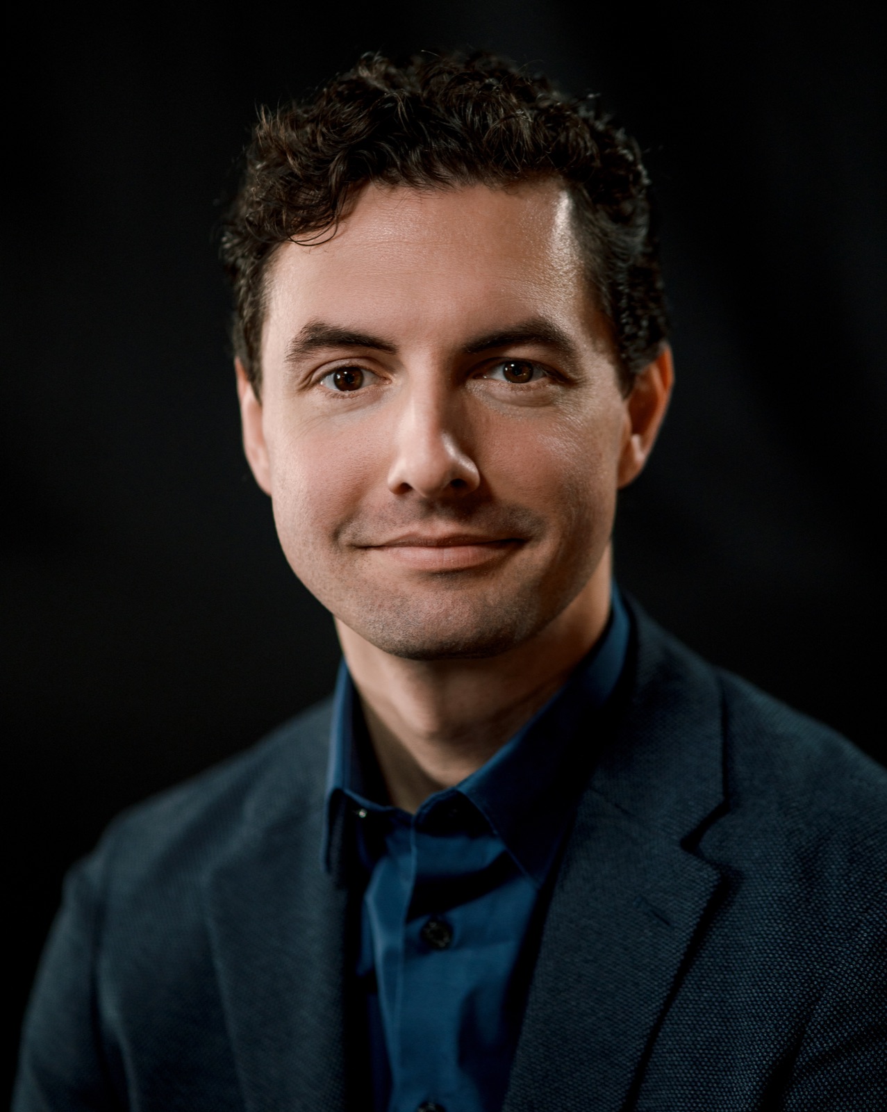 Corporate headshot on a black background