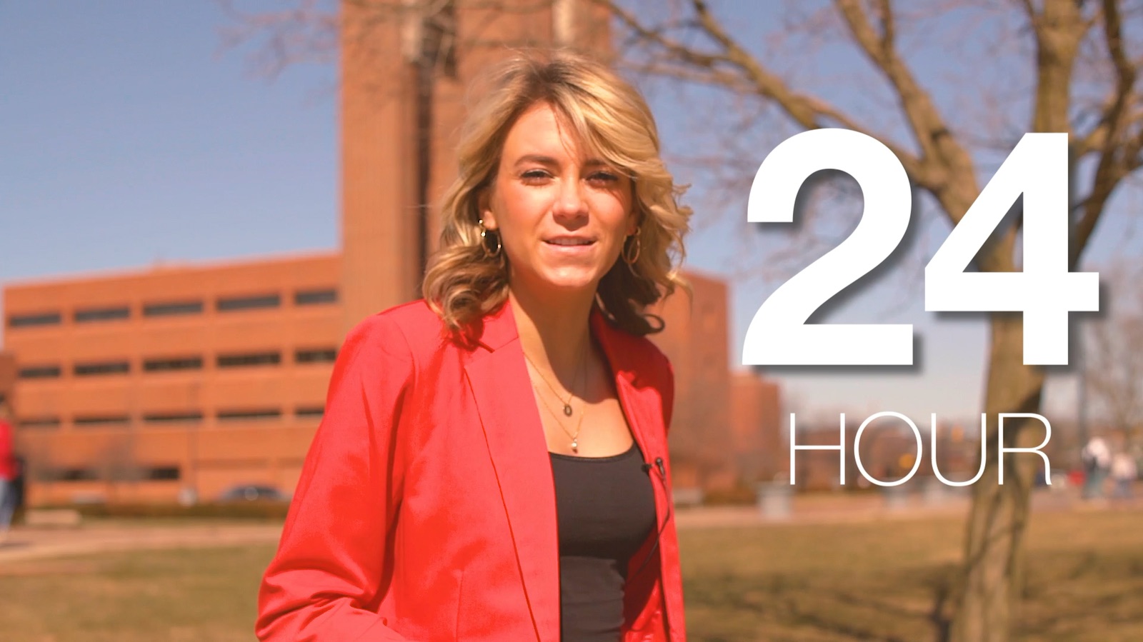 Host in a red blazer beside a 24 HOUR title