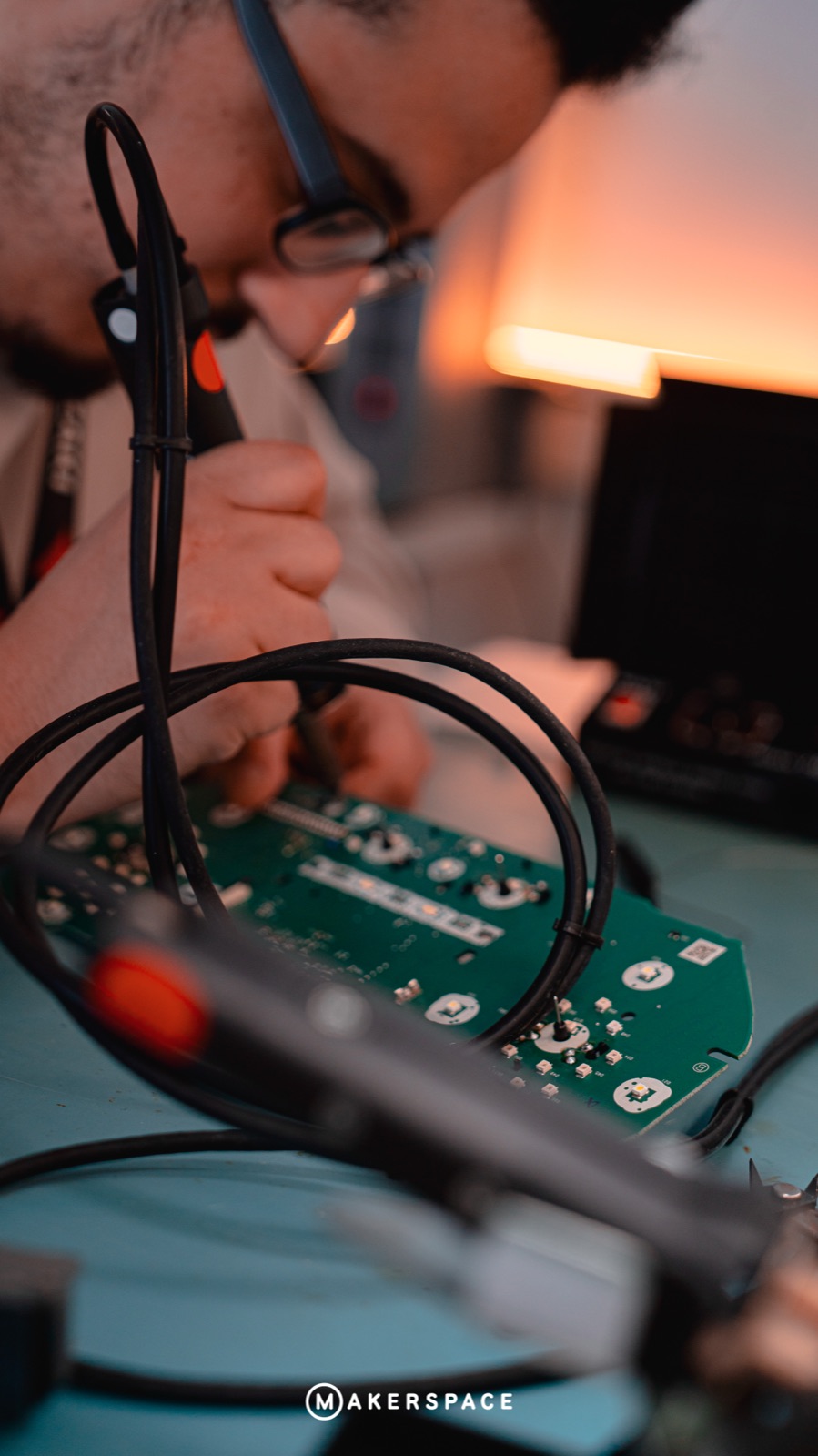 Hands soldering a circuit board