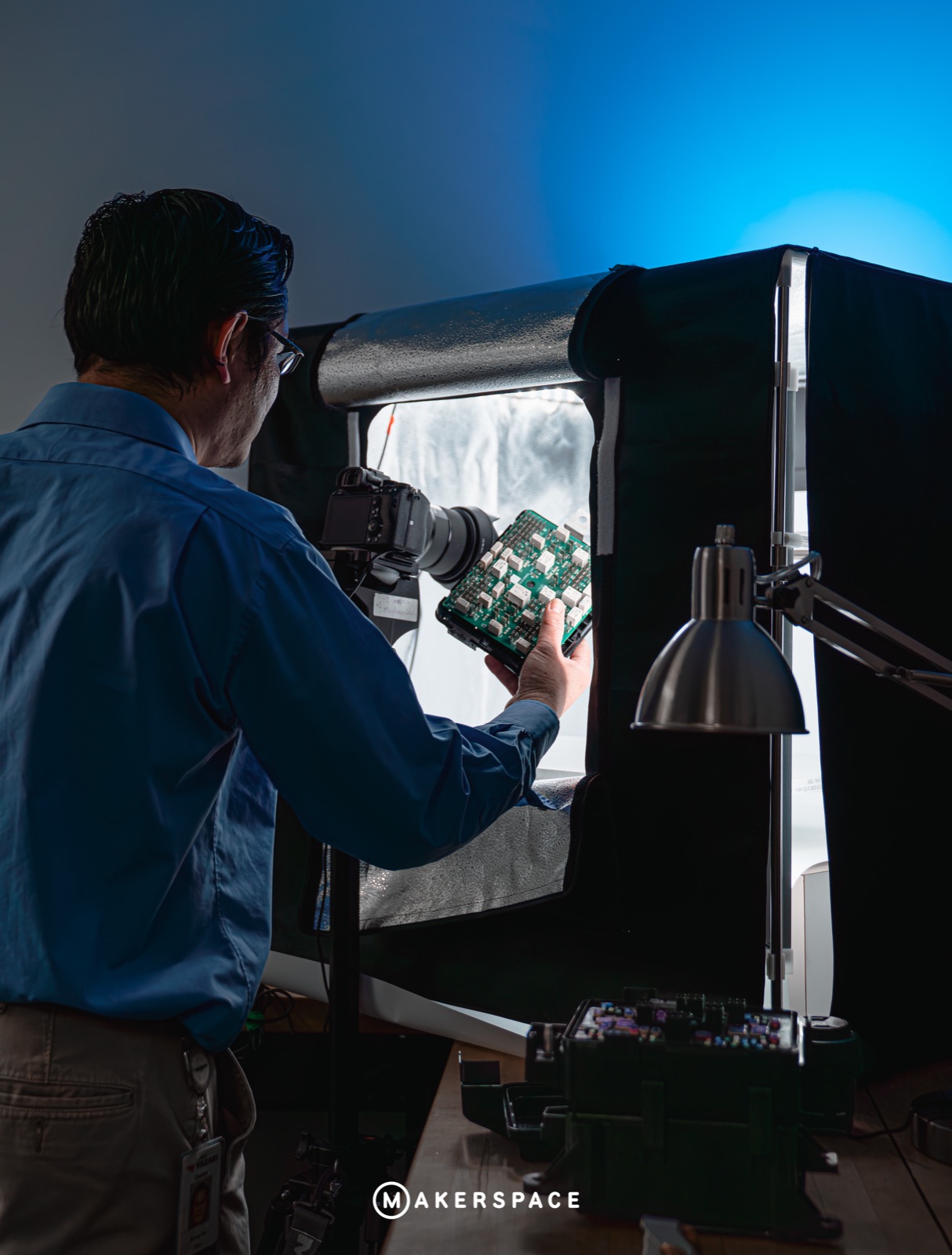 Maker photographing a circuit board in a light box