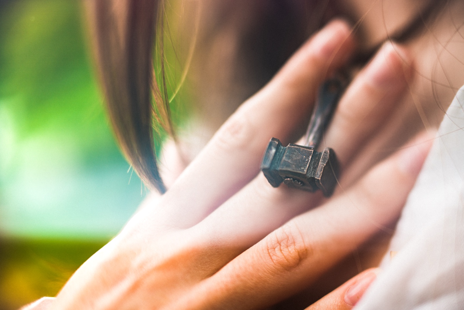Hand wearing a forged metal ring