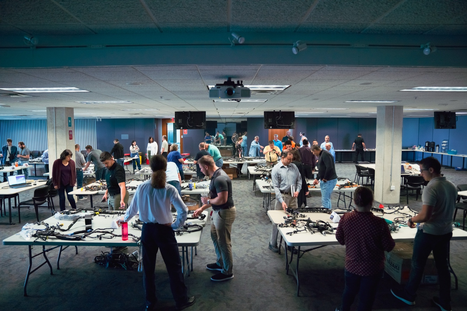 Large room of engineers at harness tables