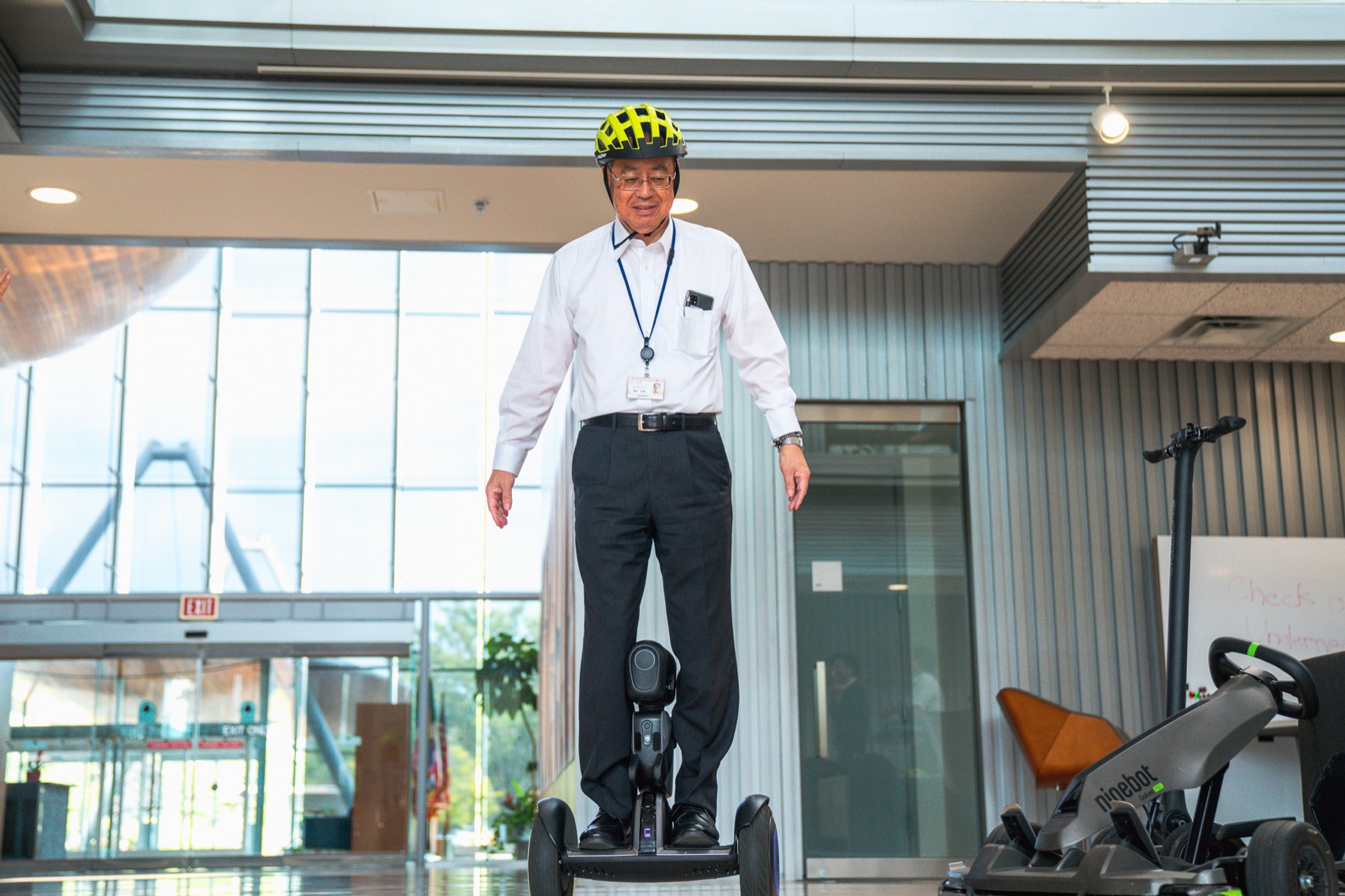 Engineer riding a self-balancing scooter in the lobby