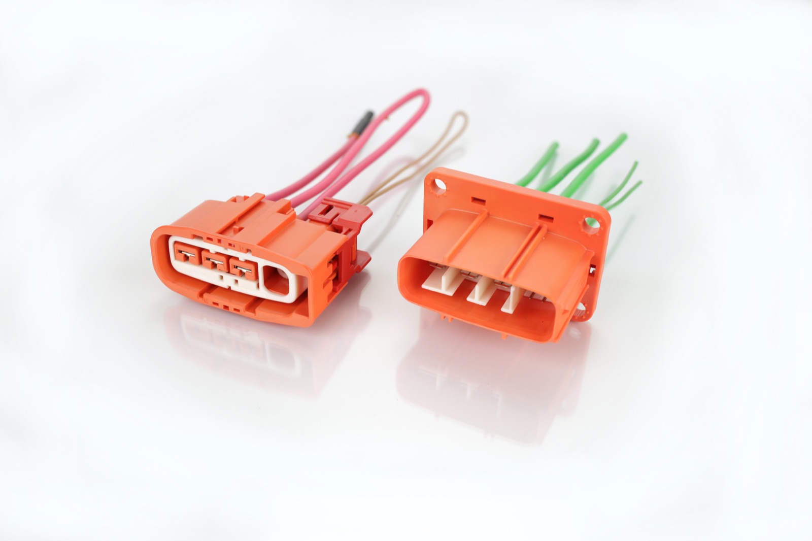 Orange high-voltage connectors on white